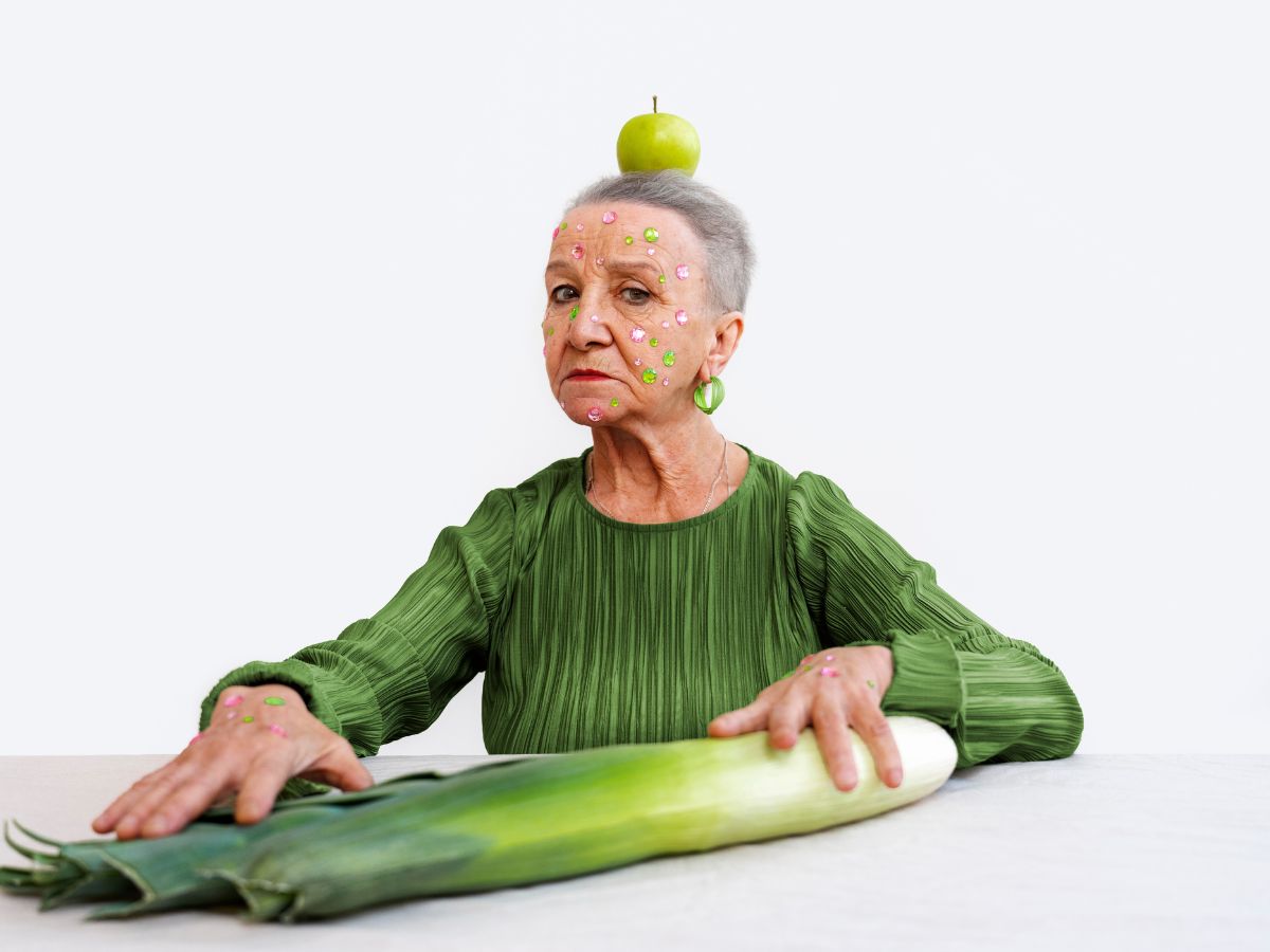 mujer de 65-70 años con alimentos coloridos, mostrando salud y energía.